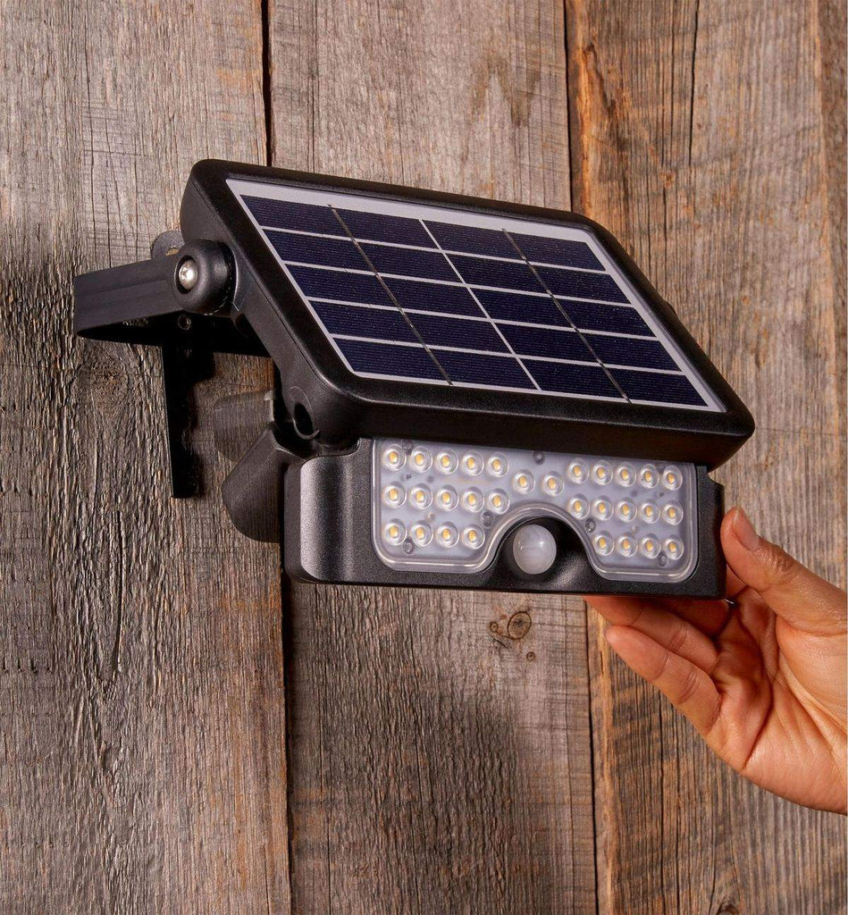Solar motion sensor security light LED outdoor flood light with IP65 waterproof rating mounted on wall
