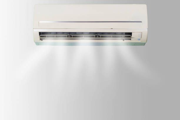 Wall mounted air conditioner heater unit installed on a bedroom wall with 2-in-1 cooling and heating functions