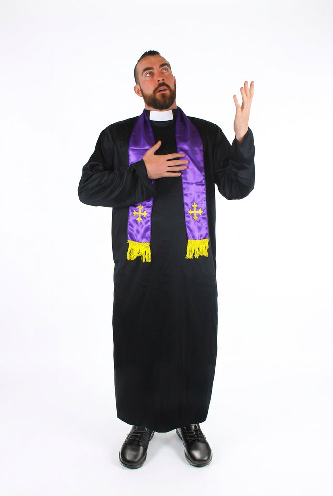 A man modeling a priest costume consisting of a black robe and a purple stole with gold trim and crosses, set against a plain white background.