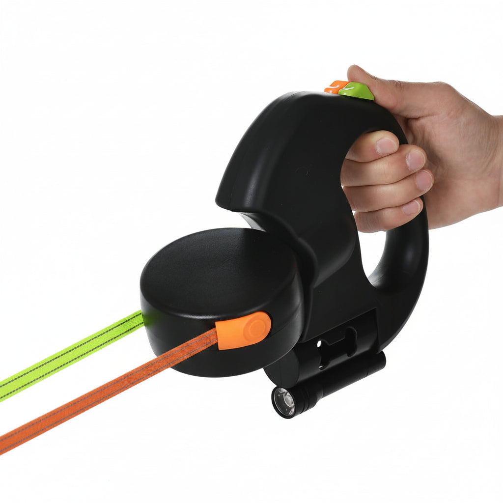 Black cable reel with green and orange cables being held by a hand on a white background