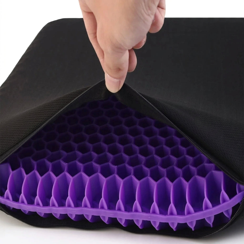 Purple honeycomb seat cushion with a black cover, showing a hand lifting the cover.