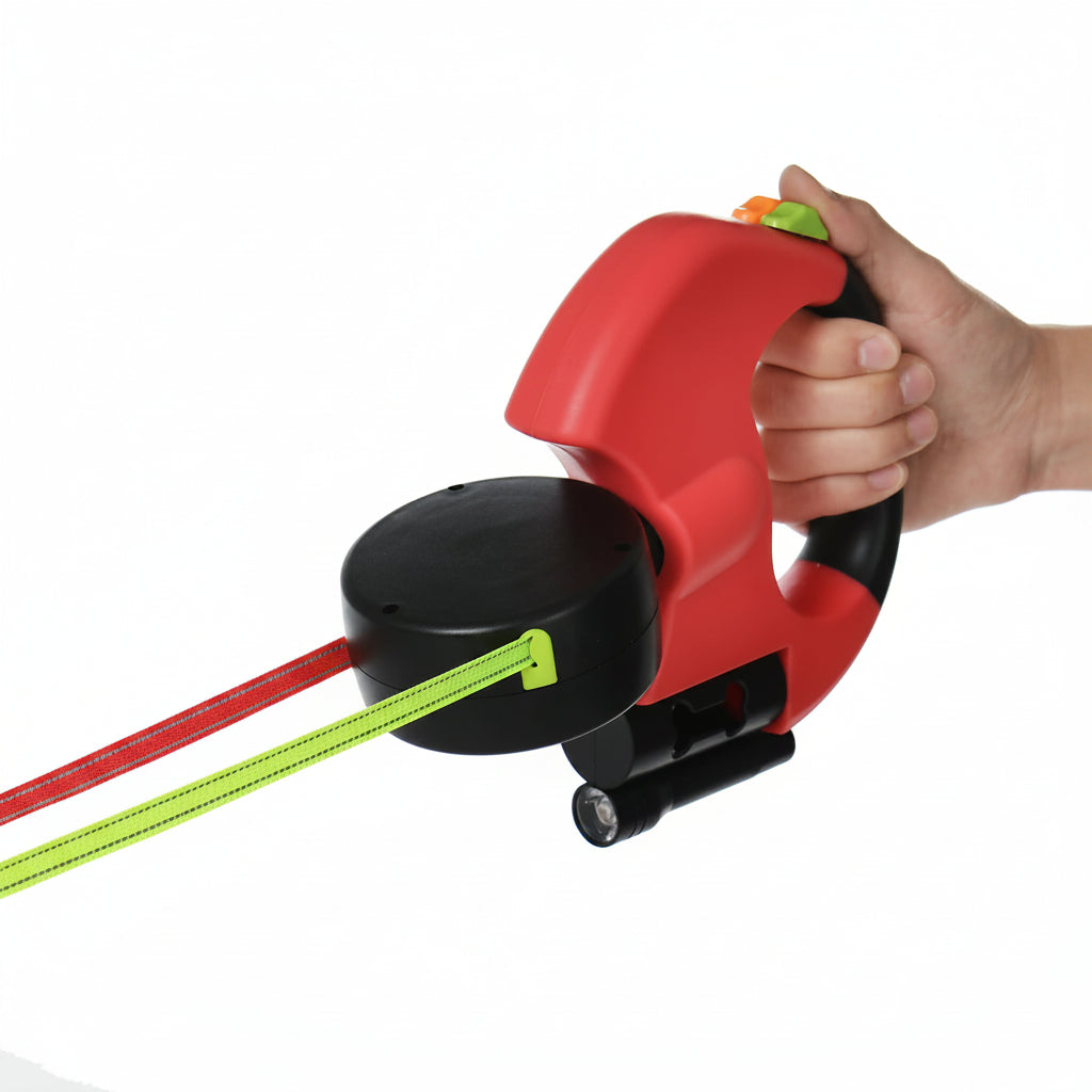 Red and black retractable dog leash with a hand holding it on a white background